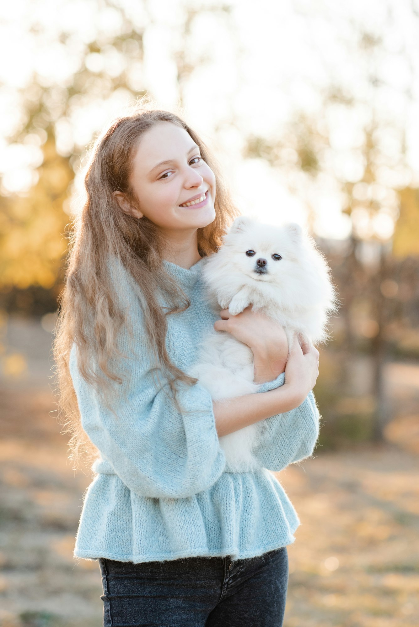 Smiling teen girl with puppy dog